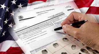 Man with American citizenship application on USA flag