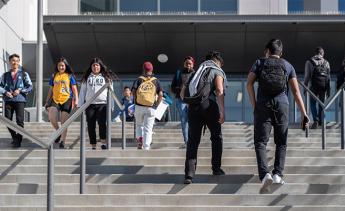 students walking to and from class by the Los Angeles Southwest College library