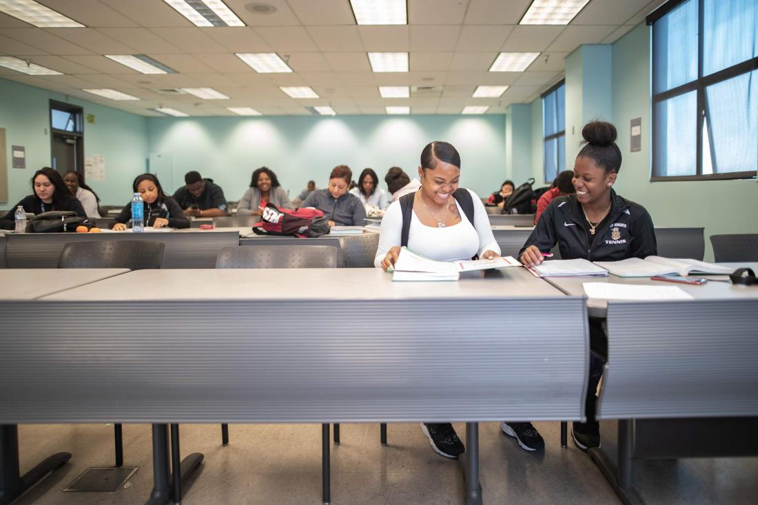 Female Students Taking Notes